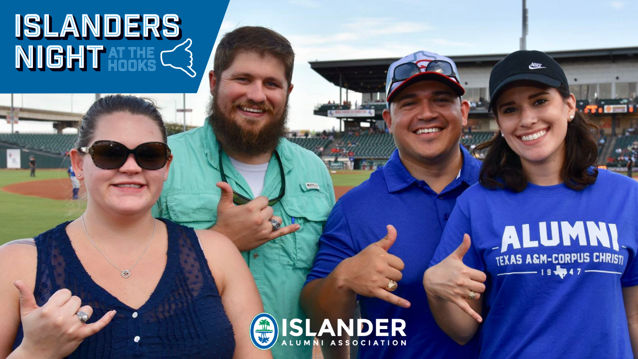 Islander alumni posing for a shakas up group photo on the field at a hooks game!